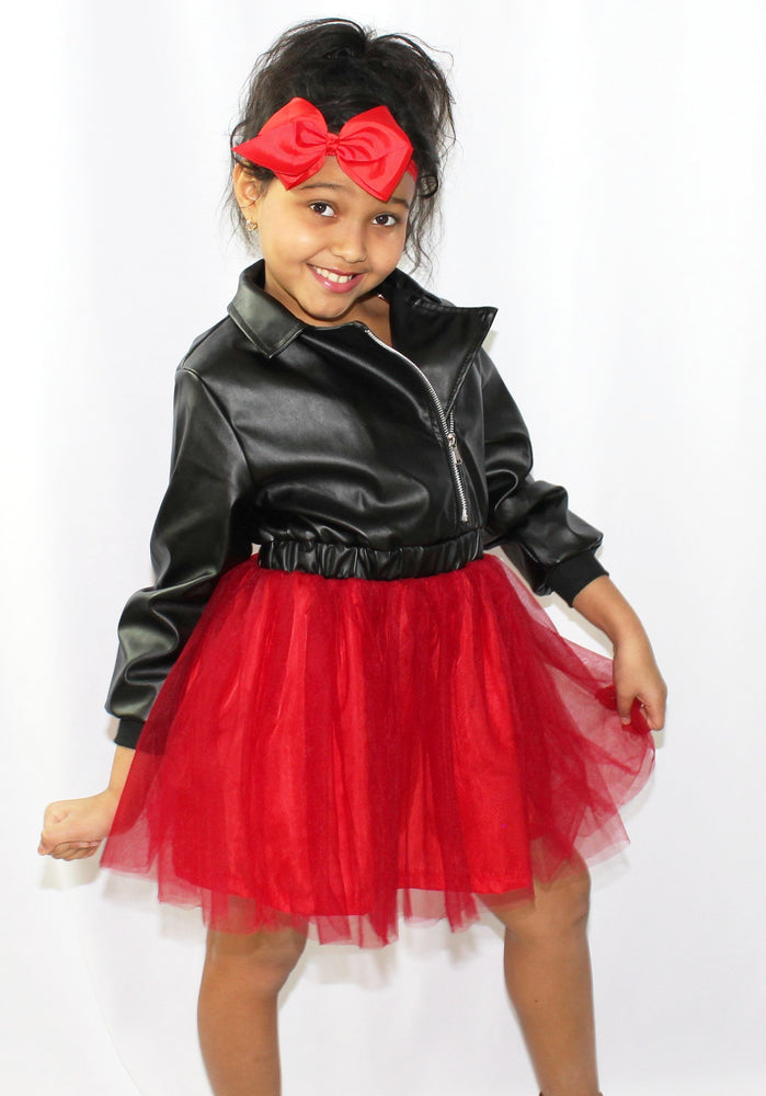 Leather tulle dress. Top part of dress is a leather jacket and the bottom has red tulle. The back of the dress is adorned with a huge diamond in sequins