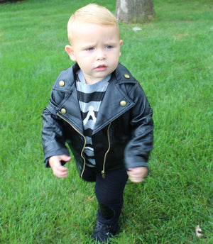 Toddler boy outfit comes with a grey and black striped t-shirt, a white crown symbol on the front and black pants with faux leather lining the knees. 