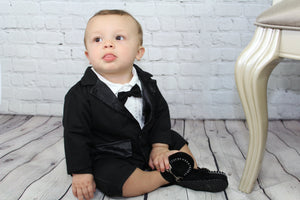 Gearing up for a fancy party? We have your little man covered with our awesome 2 piece suit set. The Classic Gentleman set comes with the one piece romper (bow tie attached and snaps at the bottom) and black cotton jacket. The jacket is not a suit jacket; it is a comfy cotton to keep your little guy comfortable. This set has all of the check lists for a super fancy outfit but will keep your baby happy because he will feel like he is in pj's! 