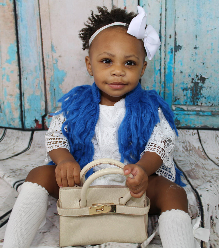 Dress your mini Diva's in this gorgeous blue pop of color for the upcoming Fall season. This vest has hooks that fasten the front closed. The Blue Fringe Vest is light and can be worn underneath a jacket if need be.