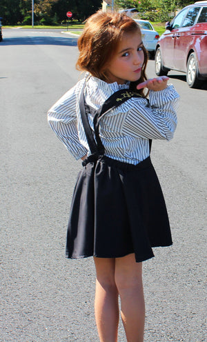 This two piece set is a perfect combo of chic and class for you mini fashionistas! This toddler set includes a long sleeve ruffled collar which fits perfectly into the halter dress. The skirt is pleated for you little princess and gold stitching lines the front and the back of the dress.