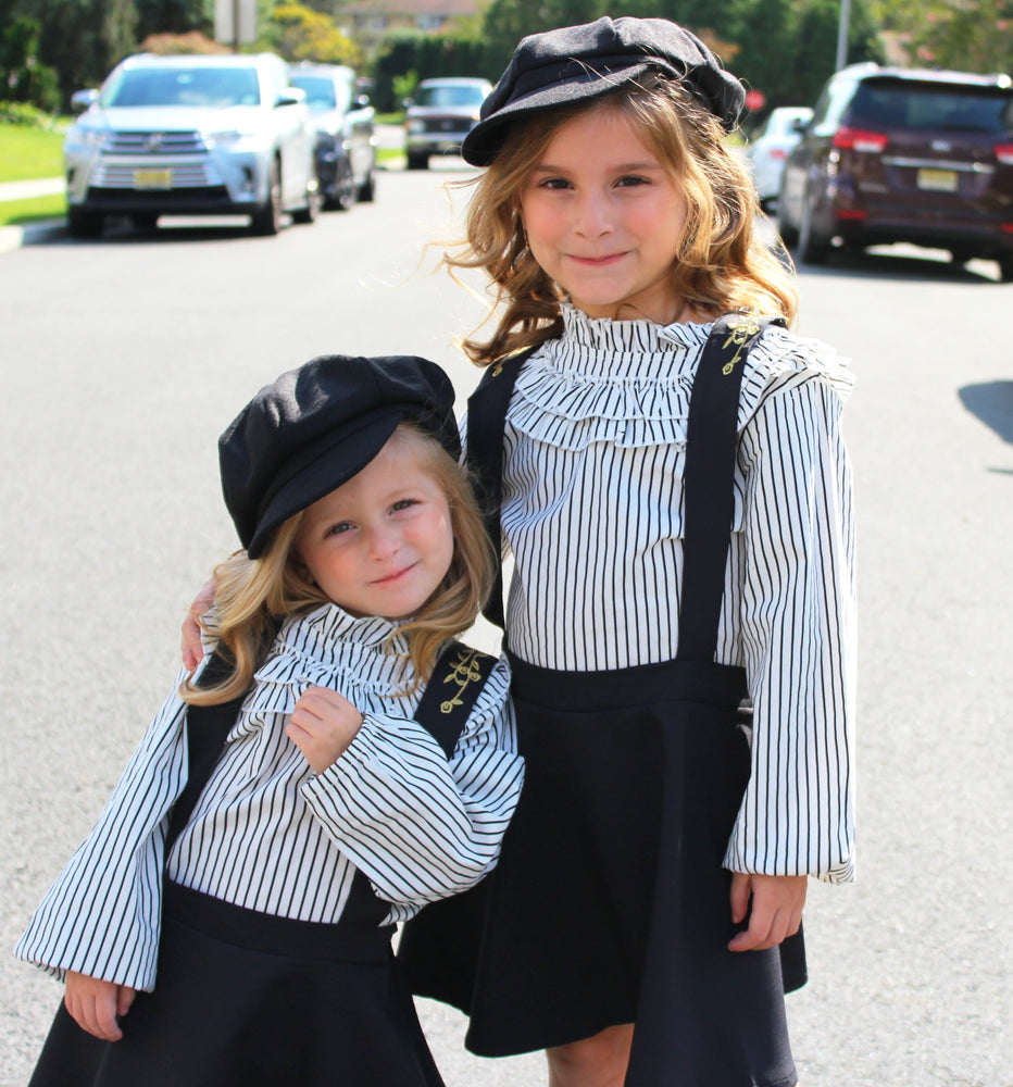 This two piece set is a perfect combo of chic and class for you mini fashionistas! This toddler set includes a long sleeve ruffled collar which fits perfectly into the halter dress. The skirt is pleated for you little princess and gold stitching lines the front and the back of the dress.