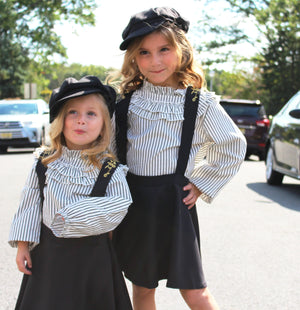 This two piece set is a perfect combo of chic and class for you mini fashionistas! This toddler set includes a long sleeve ruffled collar which fits perfectly into the halter dress. The skirt is pleated for you little princess and gold stitching lines the front and the back of the dress.