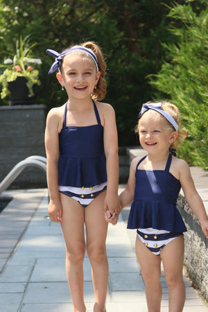 Get ready for The Hamptons with this Nautical Glam 3 piece suit. Set includes nautical colored bottom with 4 gold buttons, navy halter top and nautical striped head wrap. 