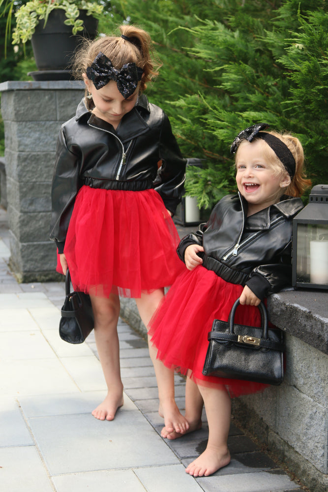 Leather tulle dress. Top part of dress is a leather jacket and the bottom has red tulle. The back of the dress is adorned with a huge diamond in sequins